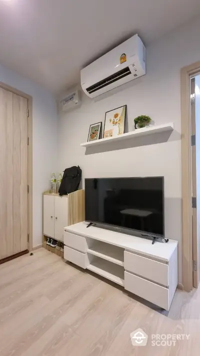 Modern living room with sleek TV stand and air conditioning unit