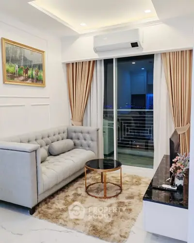 Elegant living room with plush sofa, modern decor, and balcony view in luxury apartment.