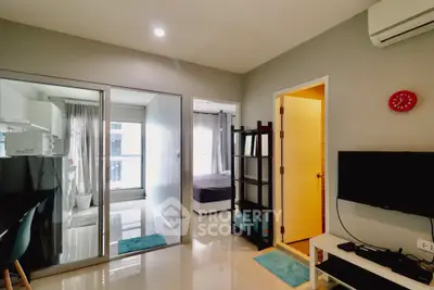 Modern apartment interior with open layout, featuring a cozy living area and bedroom view.