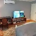 Cozy living room with elegant furniture and modern TV setup