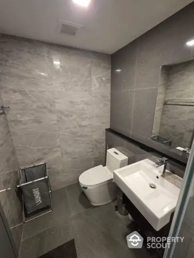 Modern bathroom with sleek gray tiles and contemporary fixtures