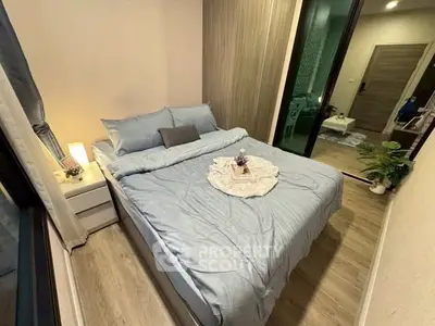 Cozy bedroom with modern decor and soft lighting, perfect for relaxation.