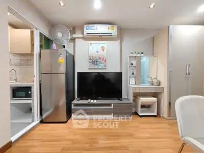 Modern living room with sleek furniture and integrated kitchen appliances.