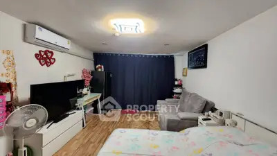 Cozy bedroom with modern decor and comfortable seating area