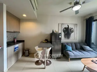 Modern apartment interior with kitchen and living area, featuring sleek design and stylish decor.