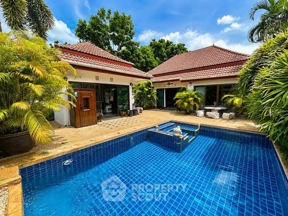 Luxurious villa with private pool and lush garden, perfect for tropical living.