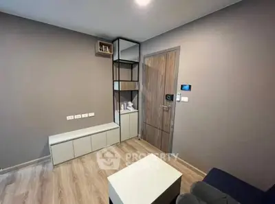 Modern living room with sleek wooden flooring and minimalist furniture design.