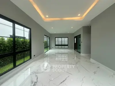 Spacious modern living room with marble flooring and large windows