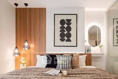 Modern bedroom with stylish decor, pendant lights, and cozy bedding for ultimate comfort.