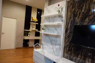 Modern living room with elegant marble feature wall and wooden flooring