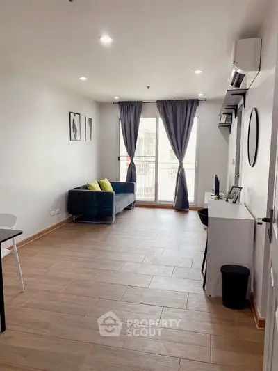 Spacious living room with modern decor and large windows for natural light.