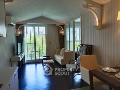 Elegant living room with modern decor and large windows offering natural light