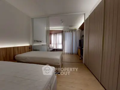 Spacious modern bedroom with stylish decor and natural light