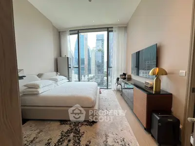 Luxurious bedroom with city view, modern decor, and floor-to-ceiling windows in high-rise apartment.