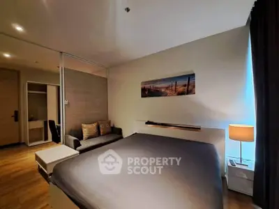 Modern bedroom with cozy lighting and stylish decor, featuring a comfortable bed and elegant furnishings.
