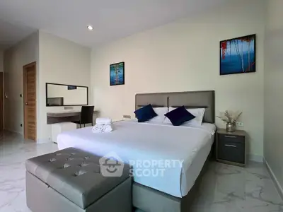 Modern bedroom with stylish decor and comfortable bed in a well-lit space.