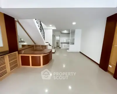 Spacious modern living room with sleek staircase and open layout