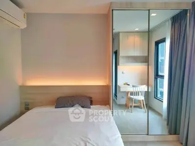 Modern bedroom with mirrored wardrobe and cozy study nook