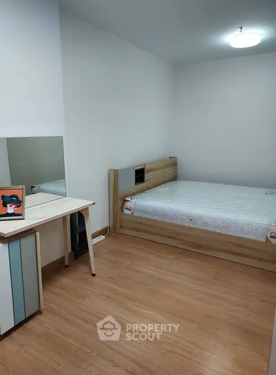 Modern bedroom with wooden flooring and minimalist furniture design