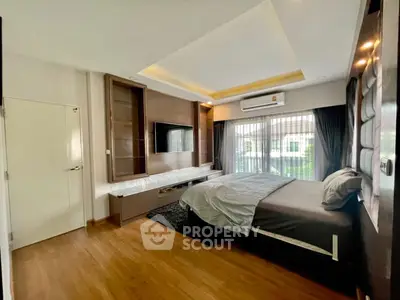 Spacious modern bedroom with large window and stylish decor