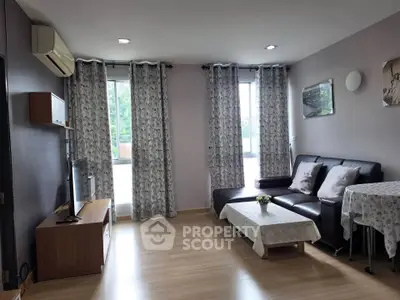 Spacious living room with modern decor and large windows for natural light.
