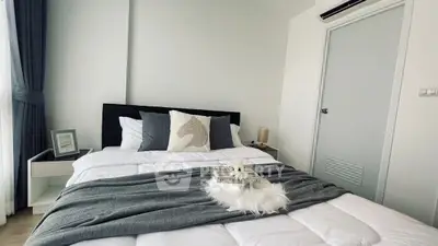 Modern bedroom with stylish decor and cozy bedding in a bright apartment.