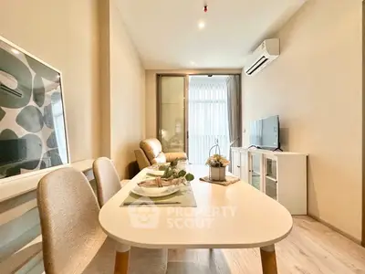 Modern living room with dining area, stylish decor, and natural light.