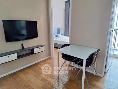 Modern apartment with sleek TV setup and cozy dining area