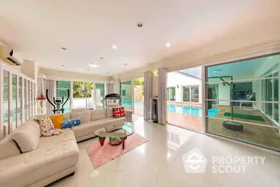 Luxurious living room with pool view and modern decor