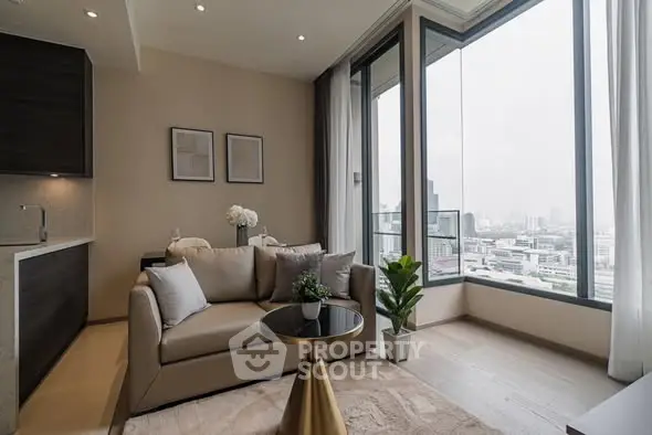 Modern living room with large windows and city view, featuring cozy seating and elegant decor.