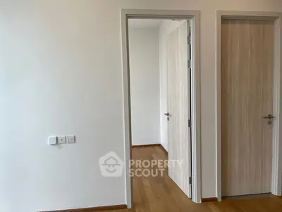 Minimalist interior with wooden doors and light walls in modern apartment