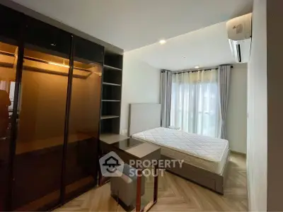 Modern bedroom with sleek wardrobe and natural light in a stylish apartment.
