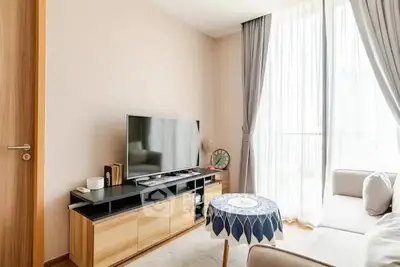 Bright and cozy living room with modern TV setup and elegant decor.