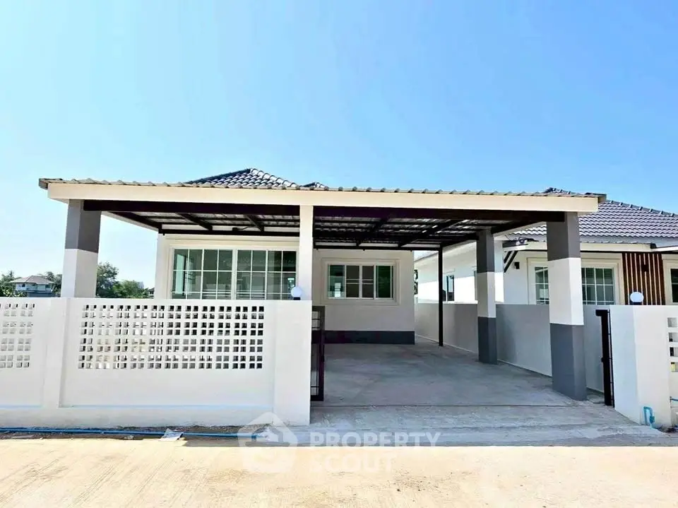 Charming single-story house with modern design and spacious carport, perfect for family living.