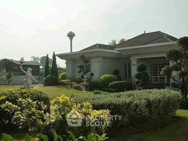Charming suburban home with lush garden and elegant landscaping, perfect for serene living.