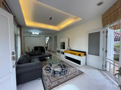 Spacious living room with modern furniture and elegant lighting in a stylish home.