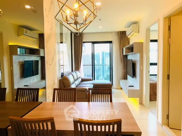 Modern living room with stylish decor and city view, featuring a cozy sofa and elegant dining area.