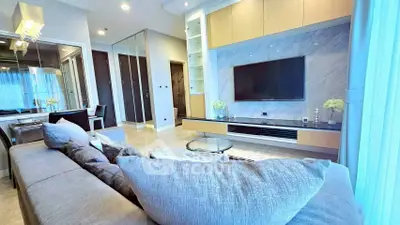 Luxurious modern living room with sleek design and large TV, perfect for relaxation and entertainment.