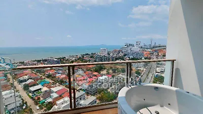 Stunning ocean view from high-rise balcony with luxurious outdoor bathtub.