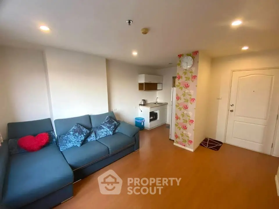Cozy living room with modern sofa and compact kitchen area