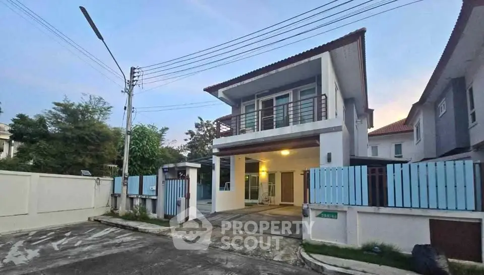 Charming two-story house with modern design and spacious driveway in a serene neighborhood.