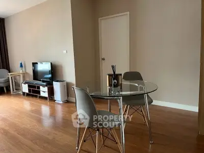 Modern living room with glass dining table and TV setup