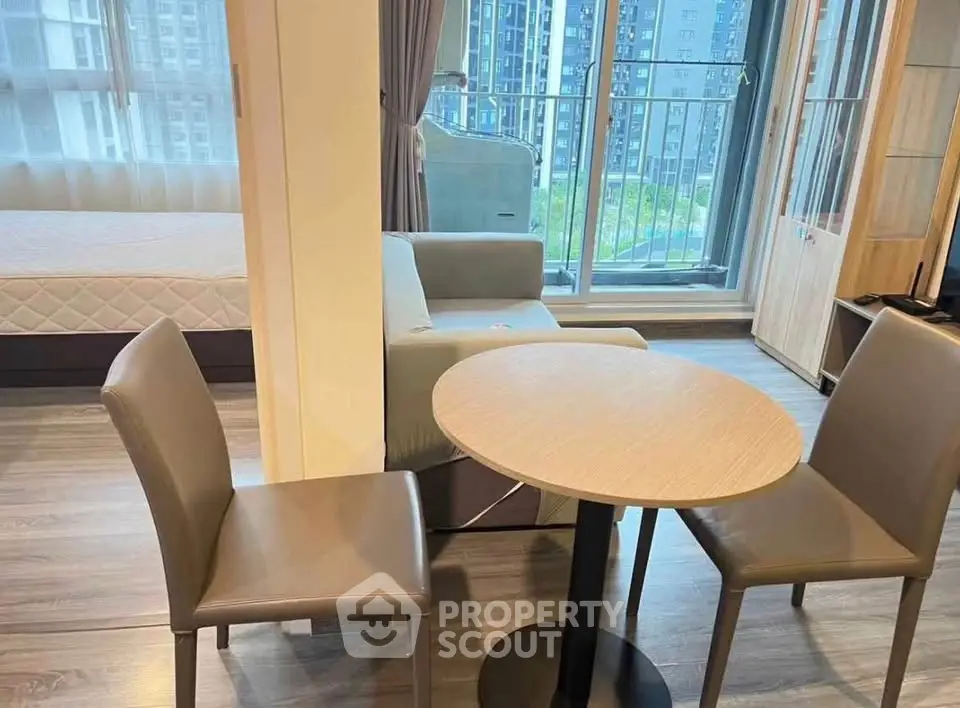 Modern studio apartment with balcony and stylish furniture in urban setting