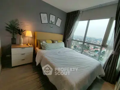 Cozy bedroom with city view, featuring modern decor and large windows for natural light.