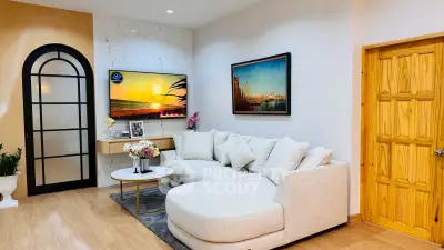 Stylish living room with modern decor, cozy sectional sofa, and wall-mounted TV in a contemporary home.