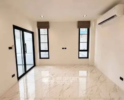 Spacious modern living room with marble flooring and large windows
