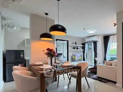 Modern open-plan living and dining area with stylish decor and natural light.