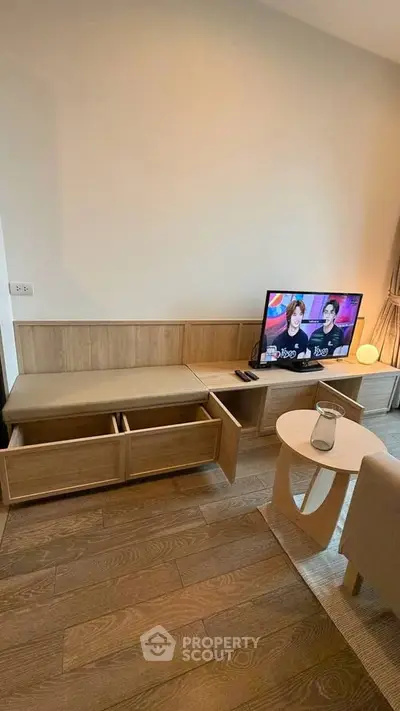 Modern living room with wooden flooring and stylish TV unit