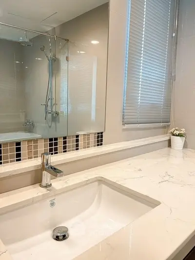 Modern bathroom with sleek sink and glass shower enclosure