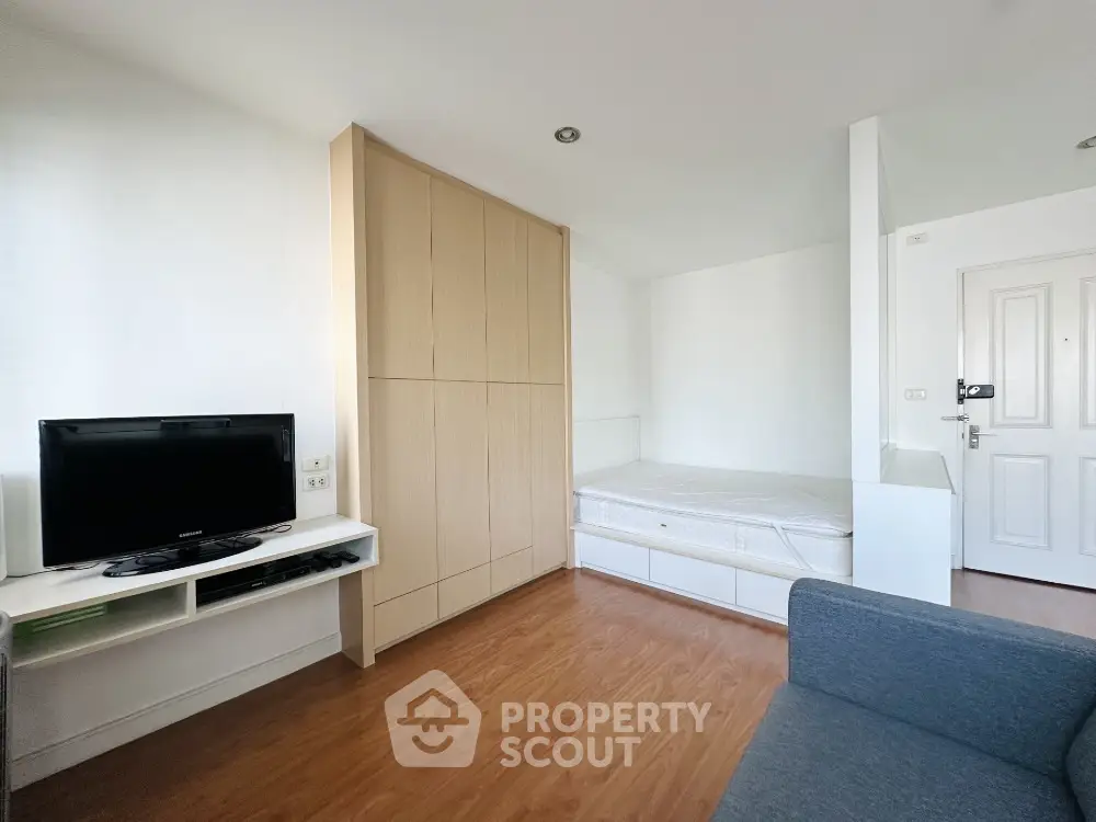 Modern studio apartment with wooden flooring and built-in wardrobe